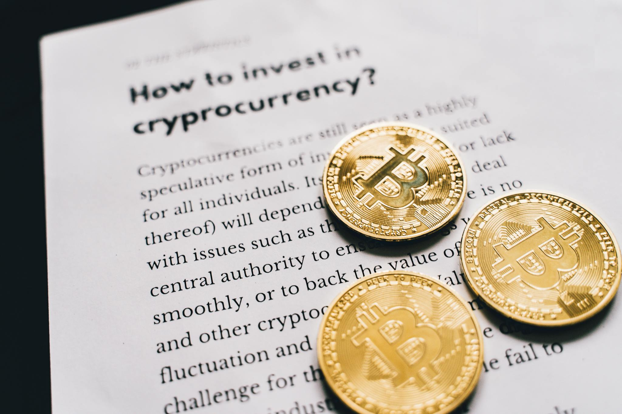 About Close-up of Bitcoin coins on an investment guide paper.